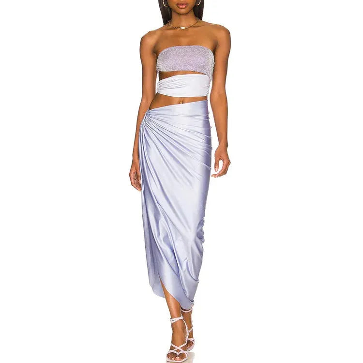 Purple women's one-piece swimsuit with hollow design and matching wrap skirt.