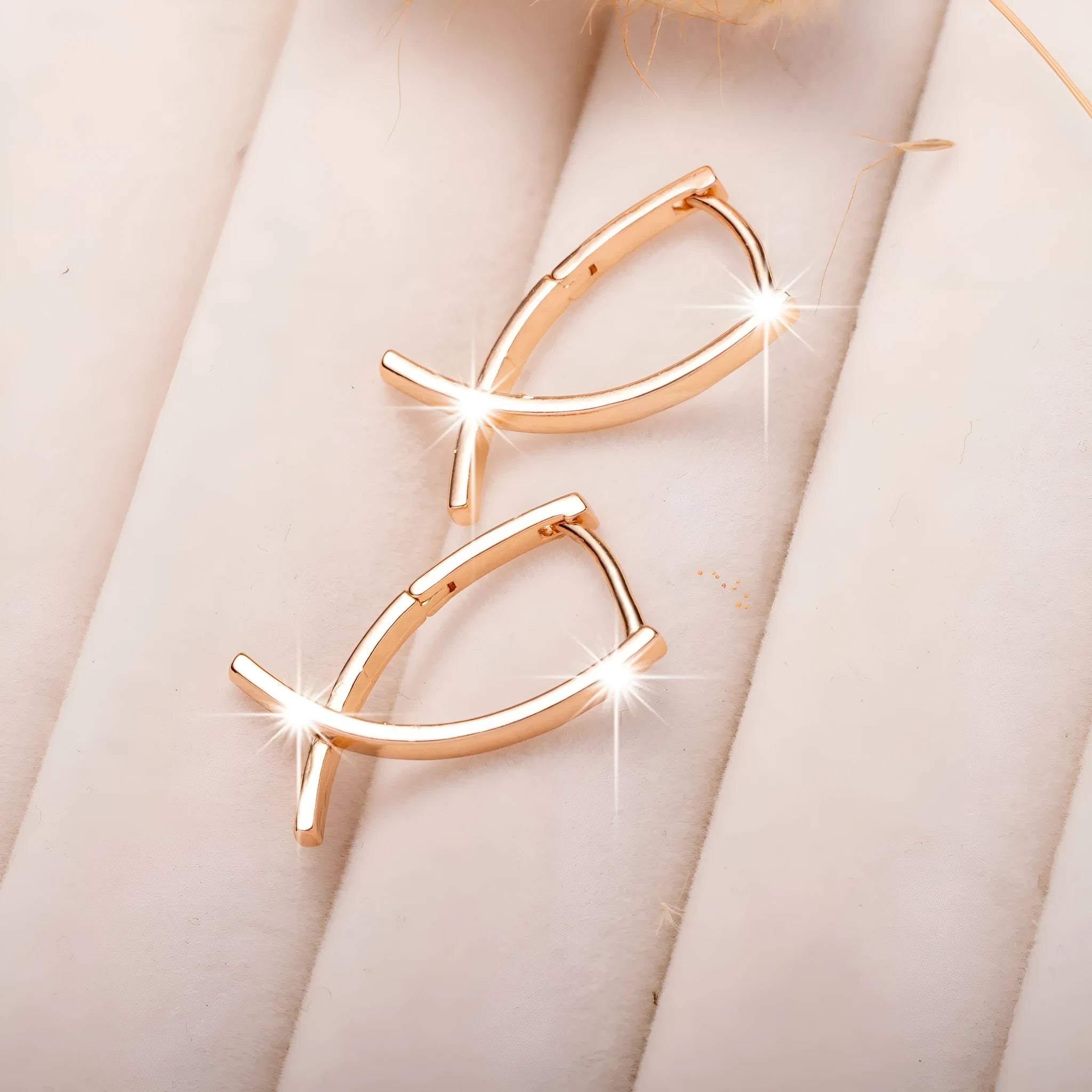 Rose gold cross shaped earrings with polished finish on copper material