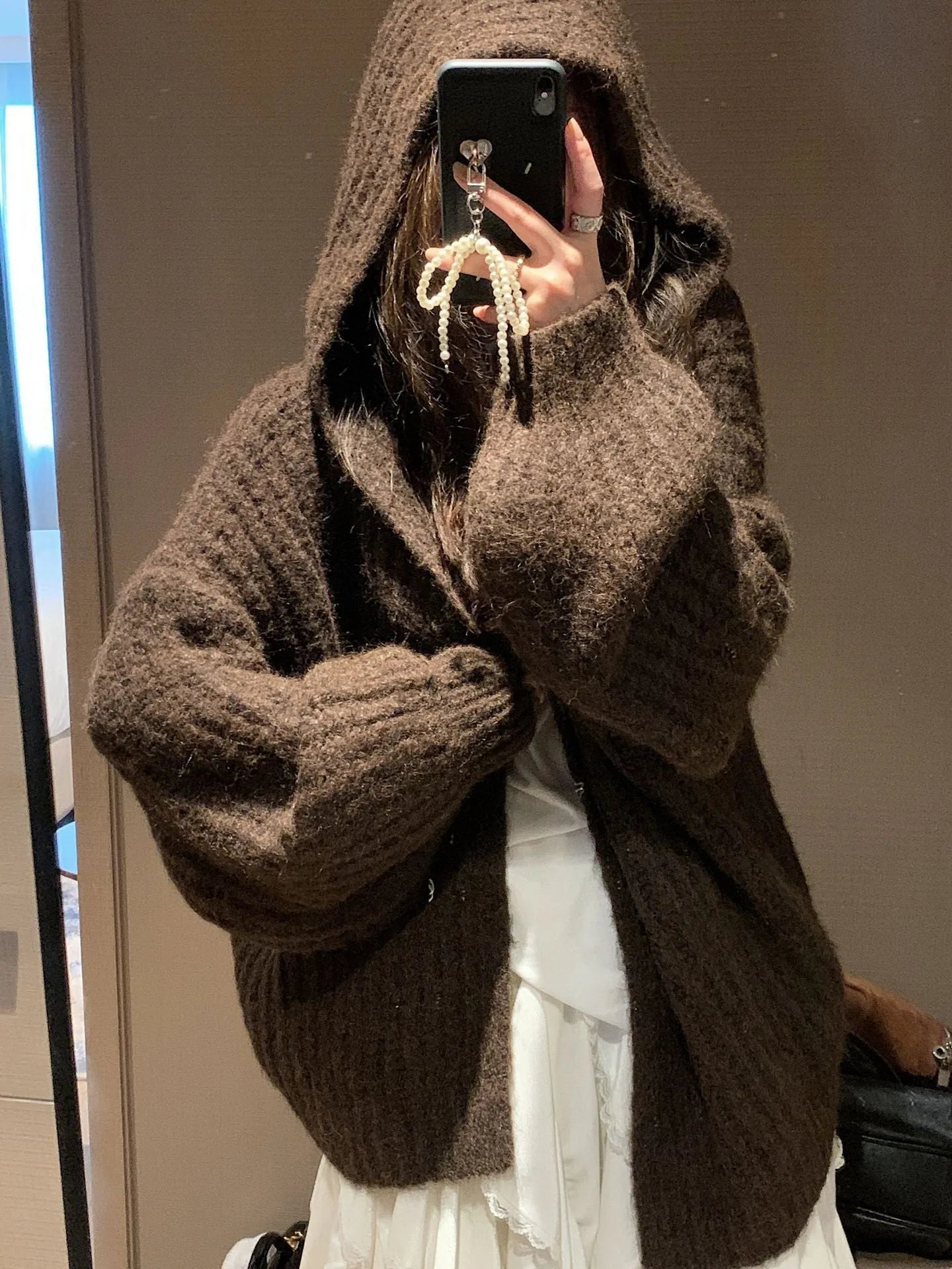 Women's dark grey retro Maillard knit hooded cardigan on a hanger, showing loose fit and regular sleeves.