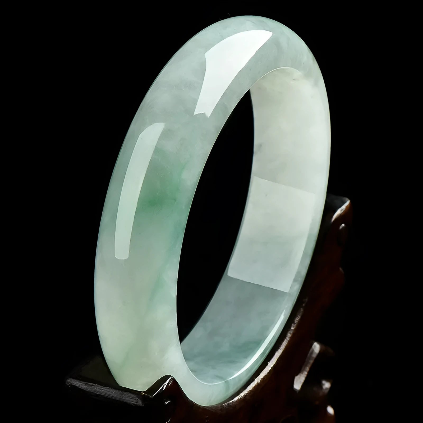 Light green jade bracelet showing natural stone texture with sizing chart displaying 53mm to 64mm circumference options