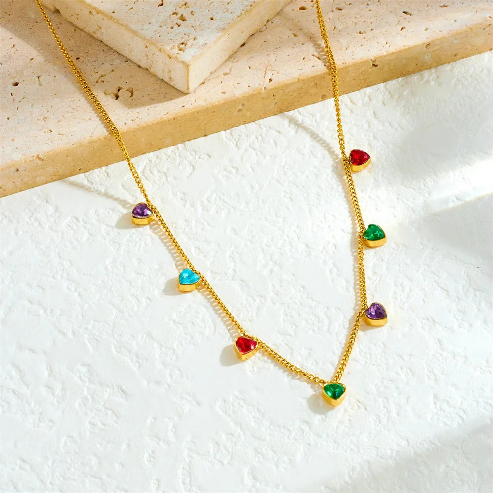 Gold-plated stainless steel heart necklace on a model, showing adjustable length.