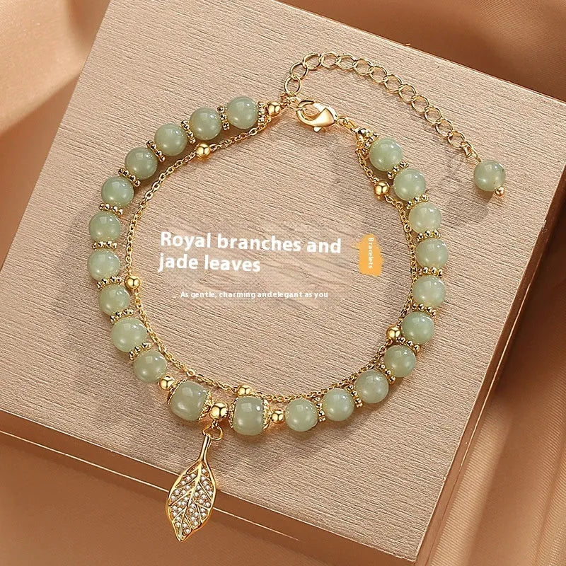 Handmade Chinese style glass bracelet with bamboo joint beads in a red Lvzhu Duobao design.