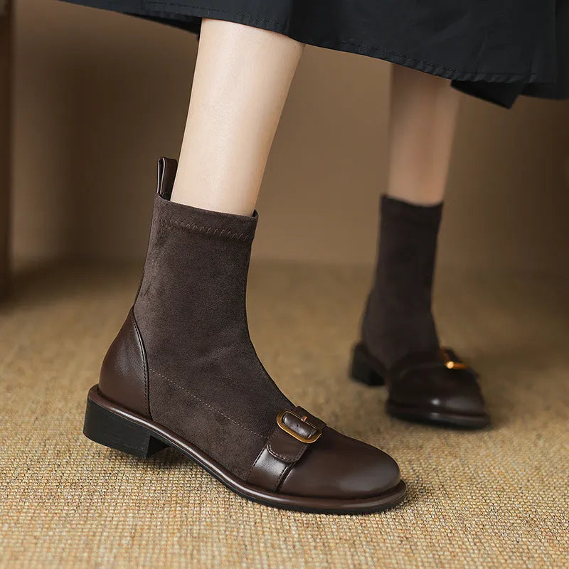 Women's black low heel Martin boots with belt buckle stitching and front lace-up closure on a round toe.