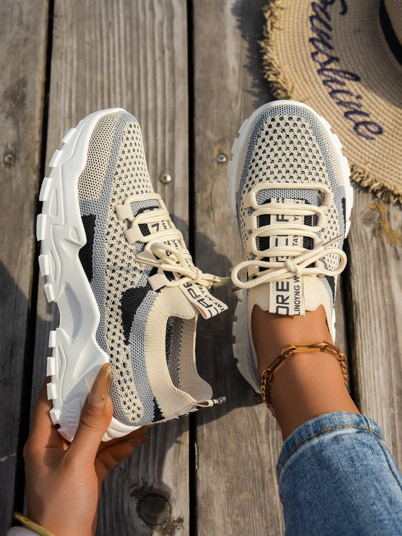Women's Flyknit mesh lace-up sneaker in a grey colourway, showing the breathable upper and rubber sole.