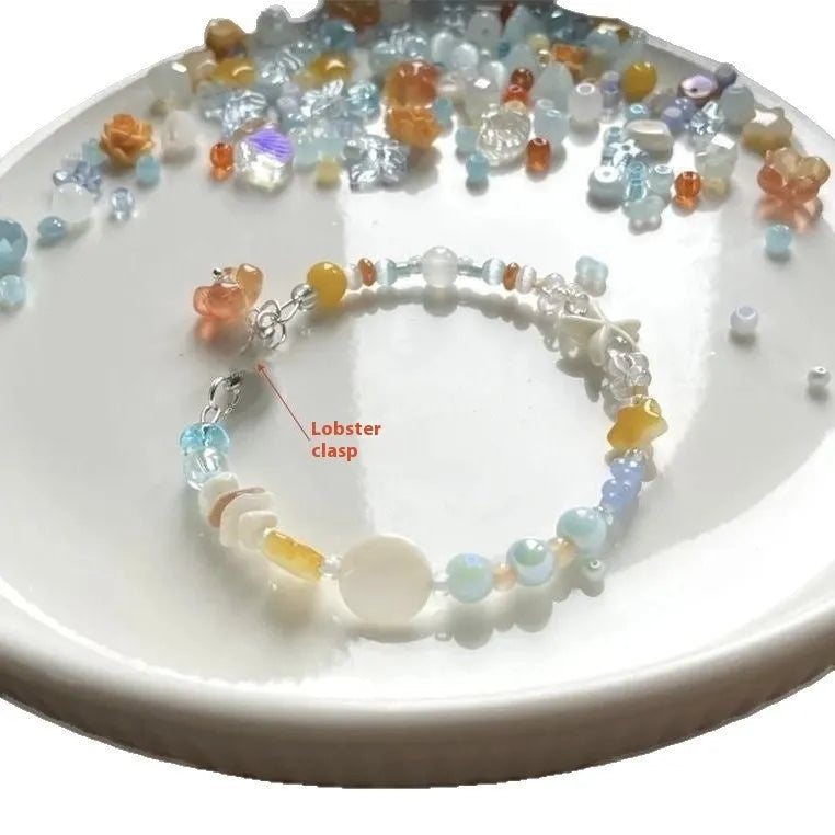 Orange mixed material alloy bracelet for women with diamond shapes and round elements.
