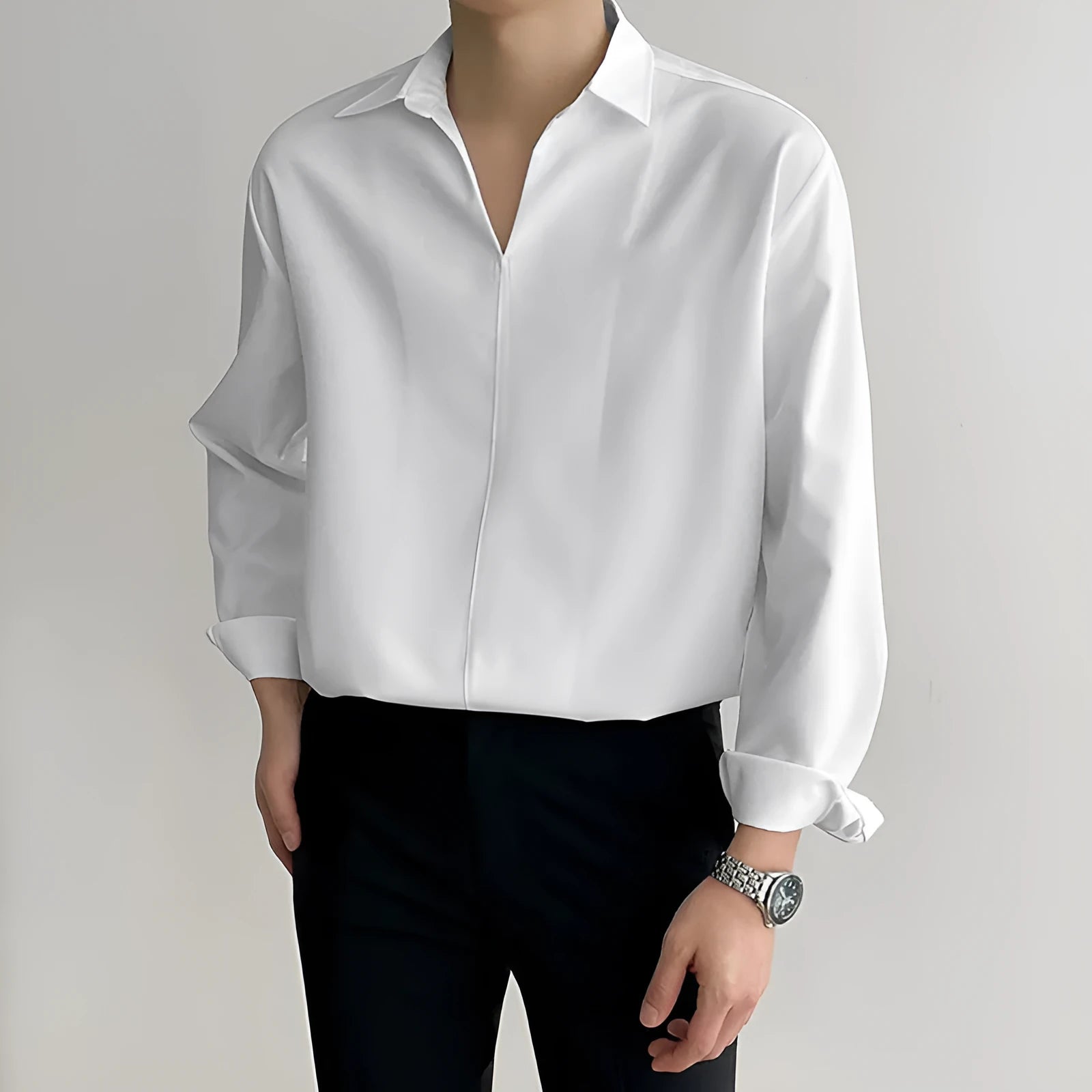 Man wearing a loose fit, solid colour, long sleeve casual shirt suitable for business.