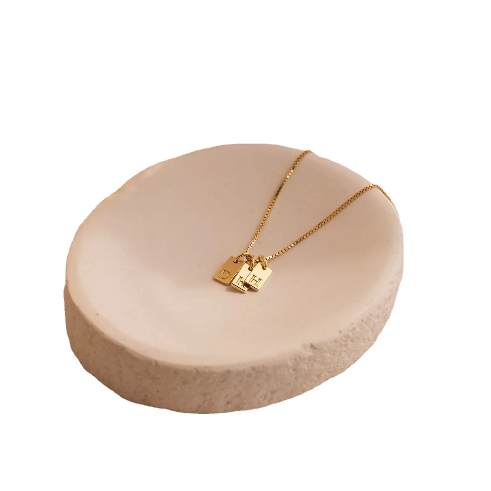 Mini square stainless steel initial necklace with gold plating on a sparkling box chain