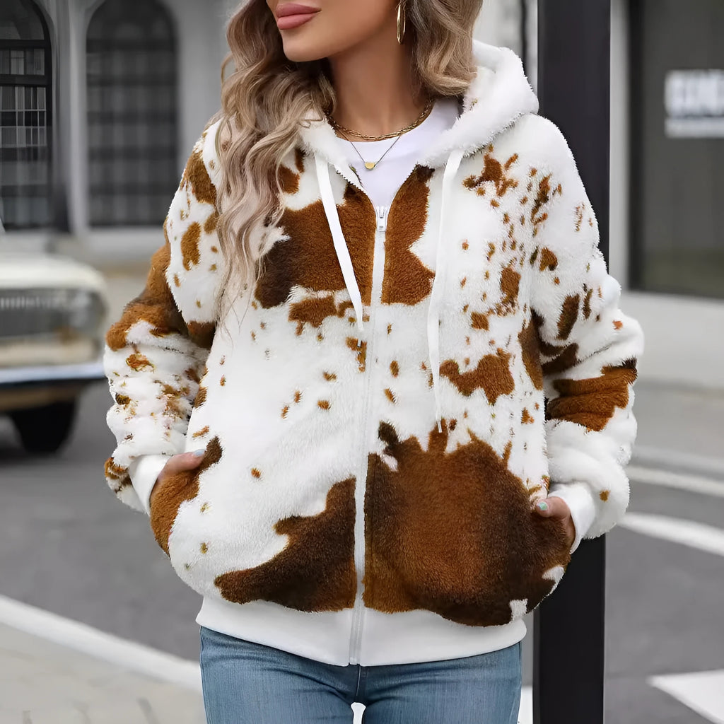 Yellow and brown cow print hooded cardigan jacket with a full front zip on a model.