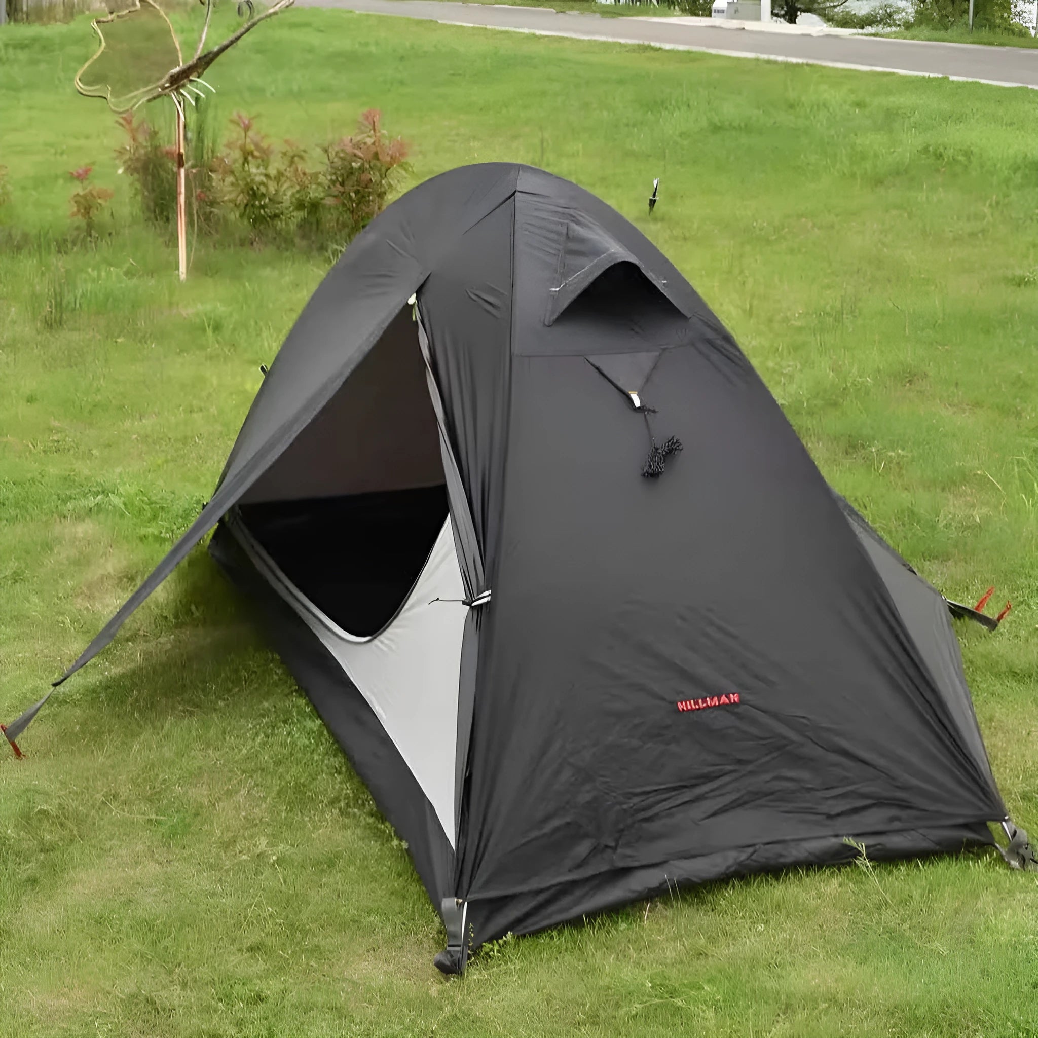 Single person backpacking tent with aluminium poles shown in a red colour option, pitched outdoors.