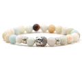 Tigereye stone Buddha head stretch bracelet with 8mm beads on a wrist.