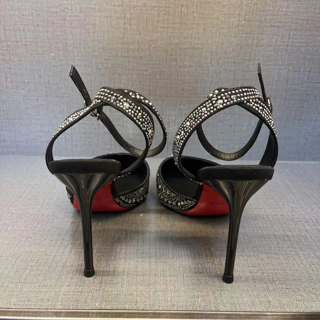 Women's silver high heels with hollow cut-out design and red stiletto heel sole.