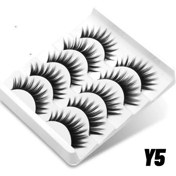 False eyelashes without eyeliner in thick natural long artificial fibre style with adhesive