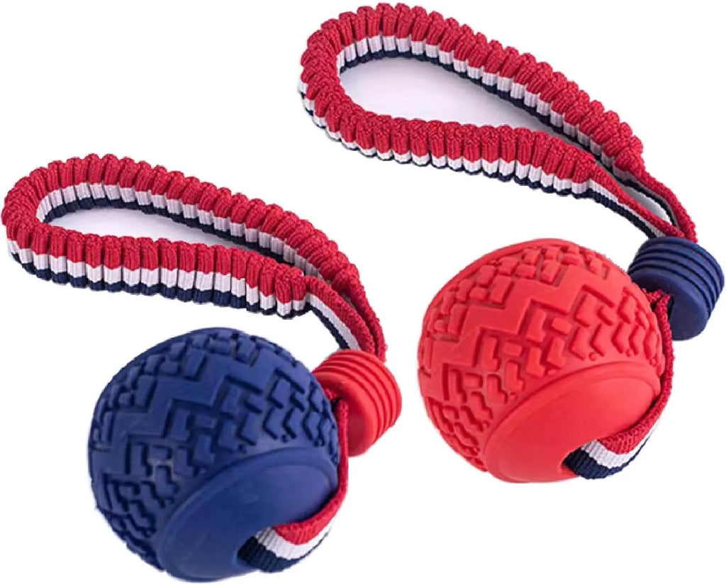 Blue or red natural rubber dog ball with rope attachment, showing textured surface and 29cm total length