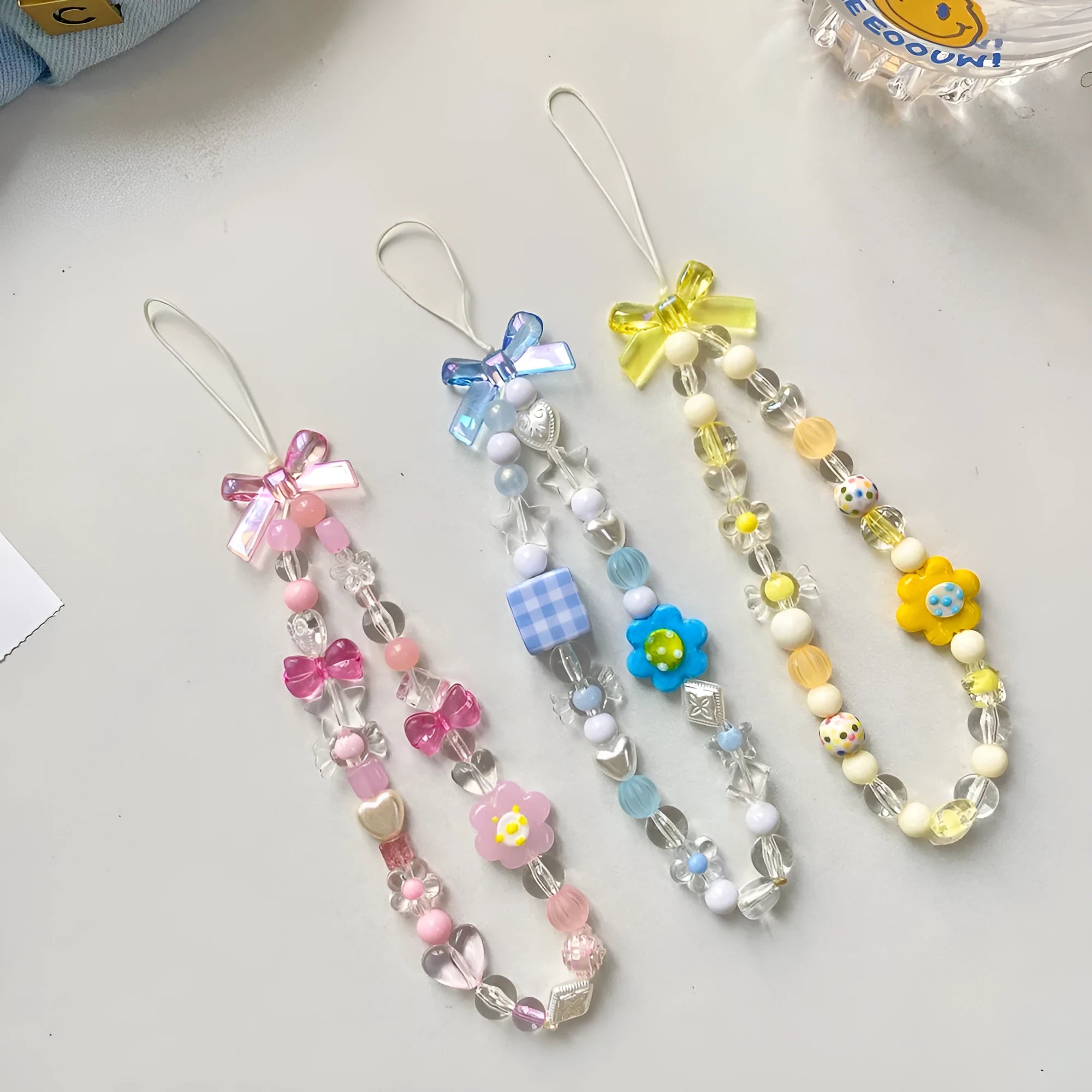 Colourful beaded flower mobile phone lanyard with plastic and resin construction