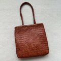 Brown handmade woven leather tote bag with outer pocket