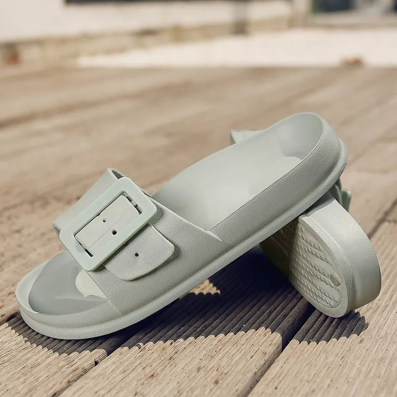 Women's grey blue buckle fastening flip-flop sandals with soft EVA sole on a white background.