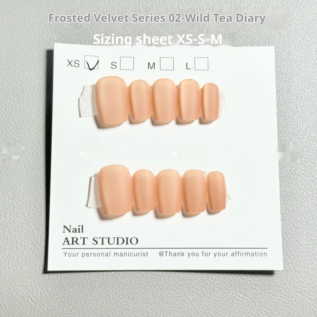False nails with frosty velvet cat's eye effect and aurora design in three short ladder sizes.
