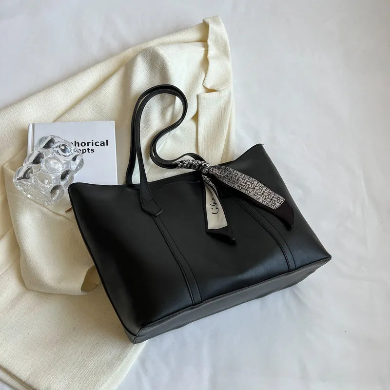Large casual tote bag with bucket shape showing internal zippered pocket and sewing line detailing