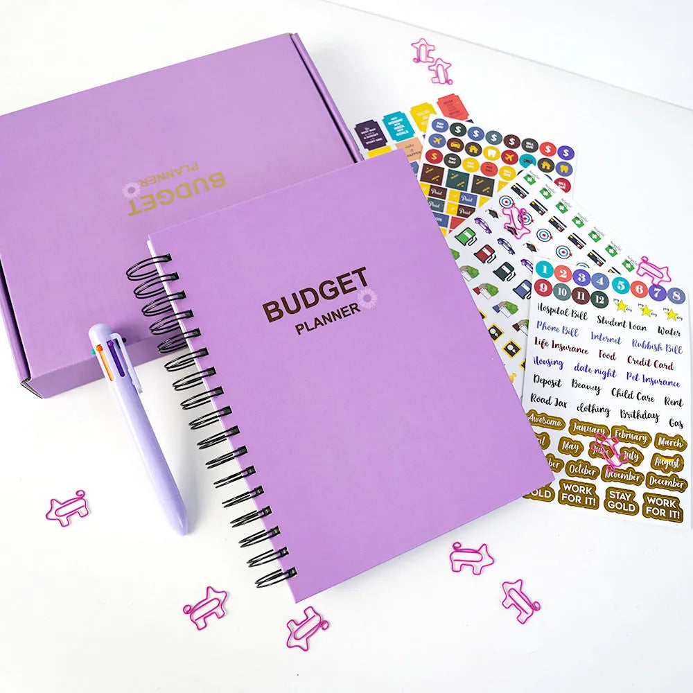 J12 purple coil-bound financial planning notebook with budget stickers and paper clips