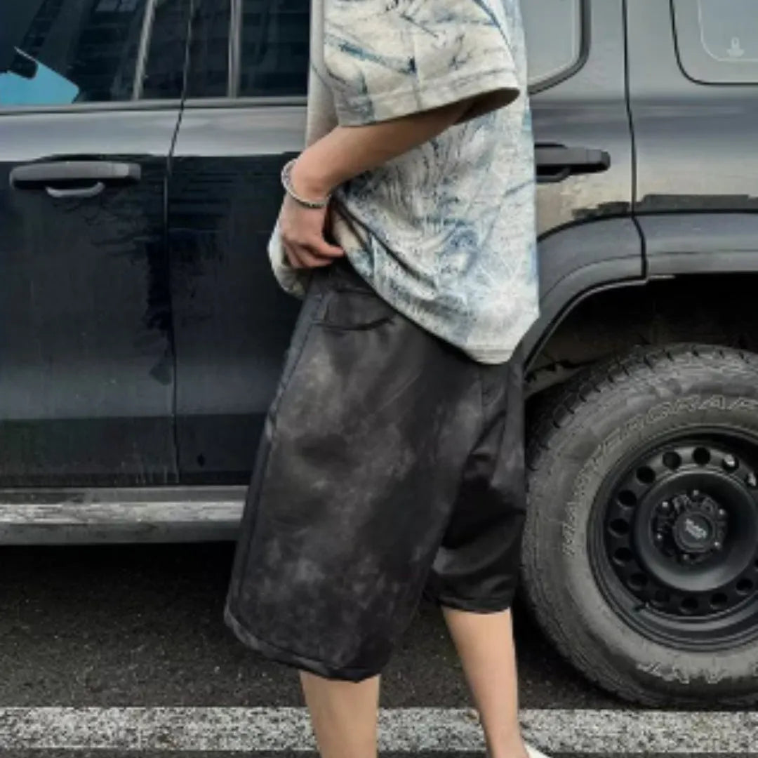 Korean style loose fit T-shirt with a full printed tie dye and dirty painting design on a solid colour background.