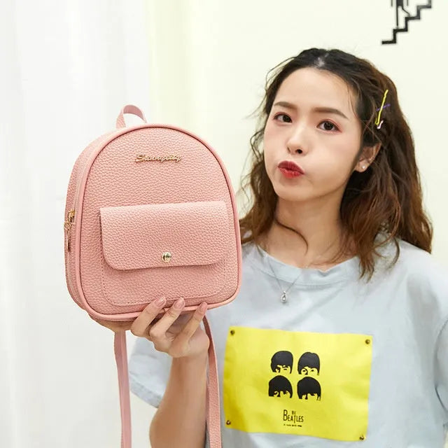 Solid colour PU leather women's small shoulder backpack with zipper, shown in available colours.