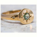 Gold-coloured adjustable ring with a star design and oval zircon stones.