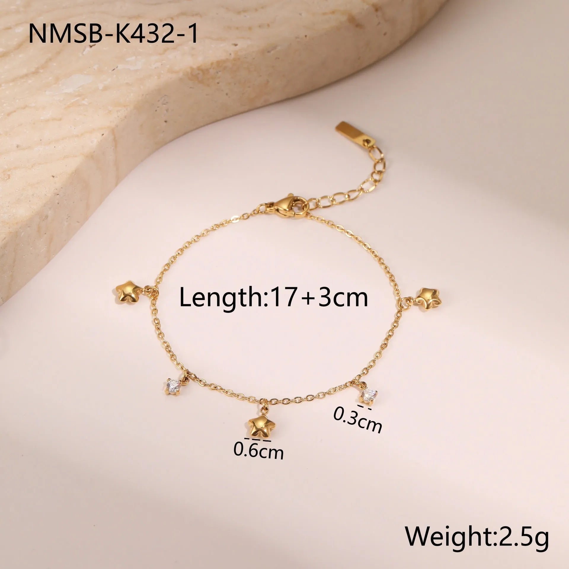 Women's stainless steel bracelet with 18K gold plating and a geometric zircon star pendant on wrist.