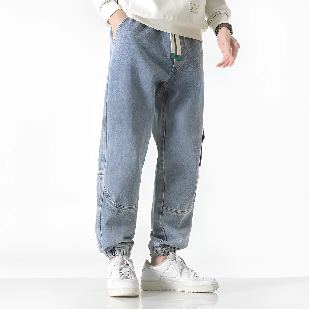 Men's loose-fit tapered cotton trousers in black, blue and grey colours showing mid-waist design