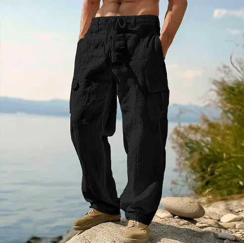 Man wearing light army green loose cotton wide-leg casual trousers with a mid waist.