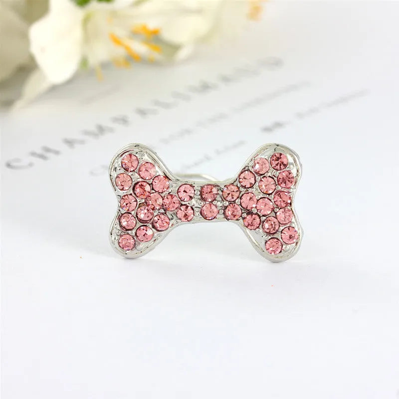 Rhinestone dog bone hair clip in alloy, white colour, on a neutral background