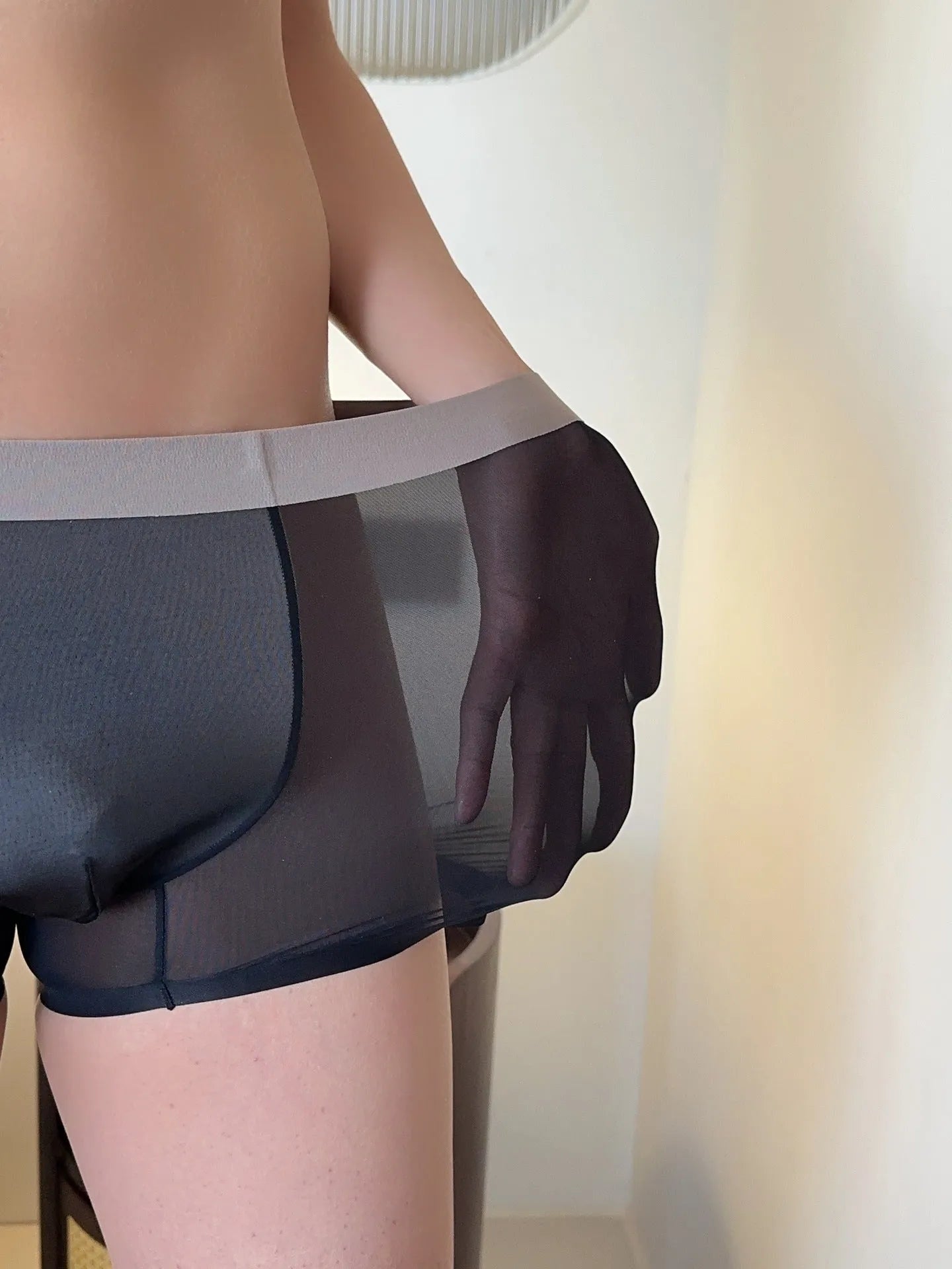 Seamless men's boxers in black Ice Silk Nylon fabric showing the honeycomb crotch and mid-waist design.
