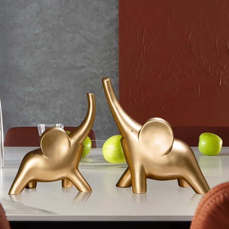 Modern resin elephant ornament in rose gold colour displayed on wooden surface