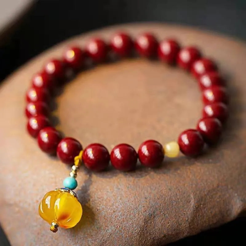 Handmade gold cinnabar wave bracelet with copper beads in national style unisex design.