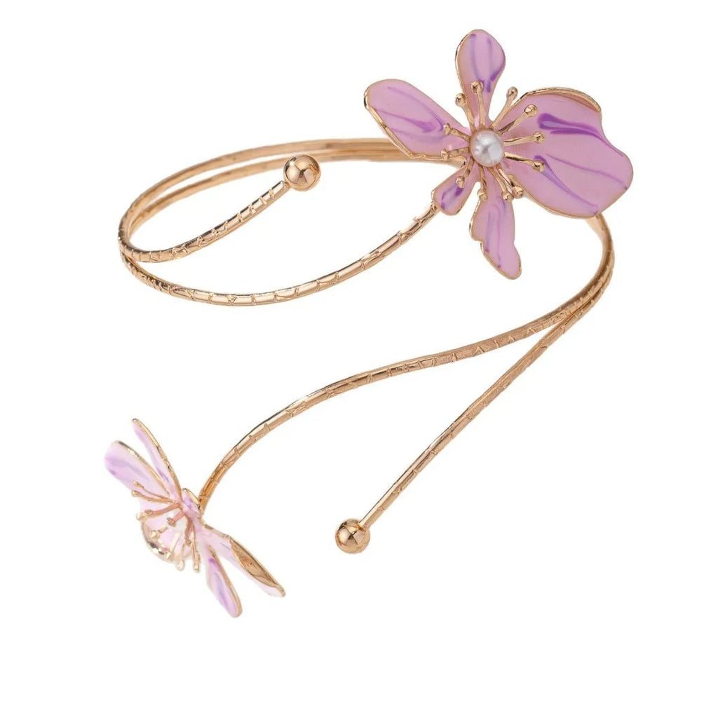 Pink alloy fashion armband with a hollow, openwork pattern shown on a wrist.