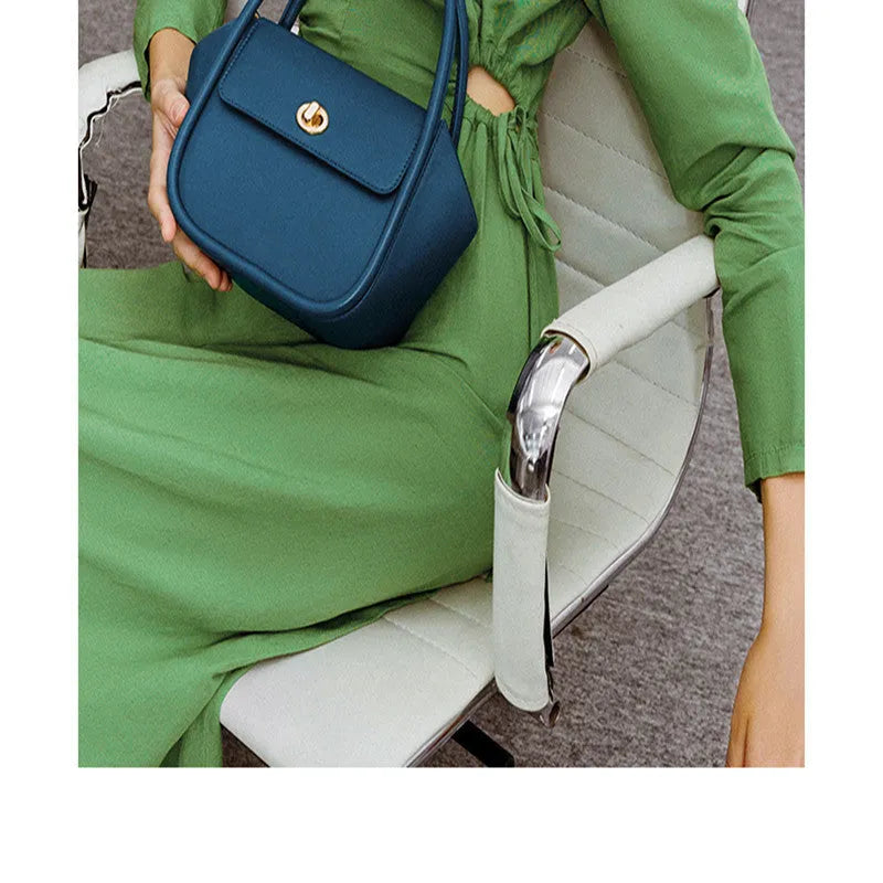 Leather wing bag with latch closure and buckle detailing in cow leather with cross-body strap