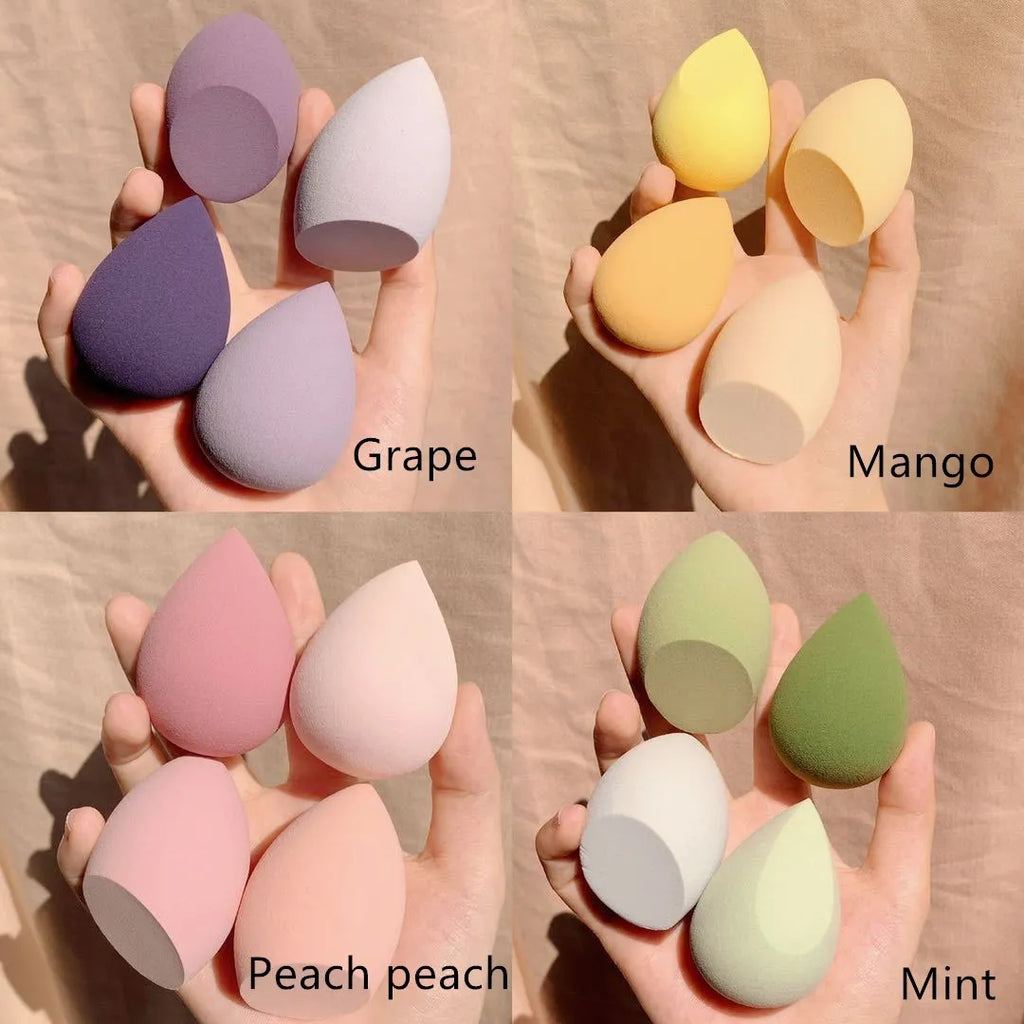 Set of four coloured makeup sponge eggs on a white background