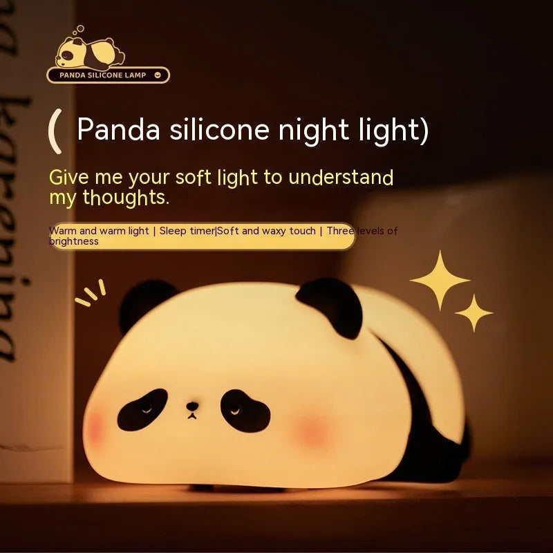 Panda shaped silicone night light with warm white glow on dark surface