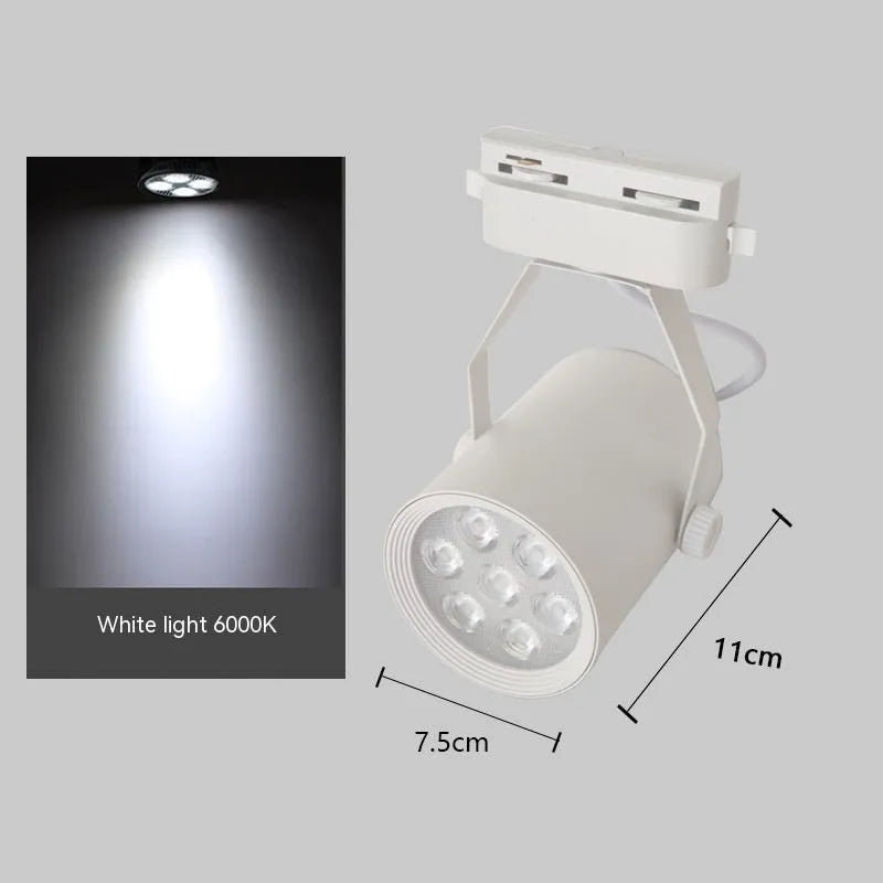 Black and white aluminium shell LED track spotlight mounted on a lighting track for display use.