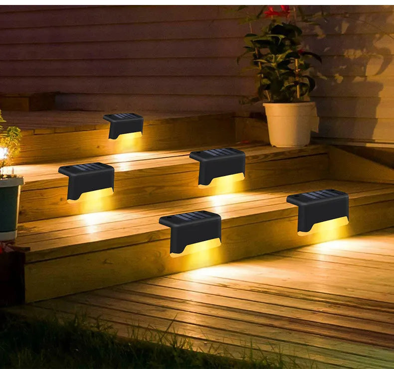 black solar courtyard stair light with ABS body on a garden step