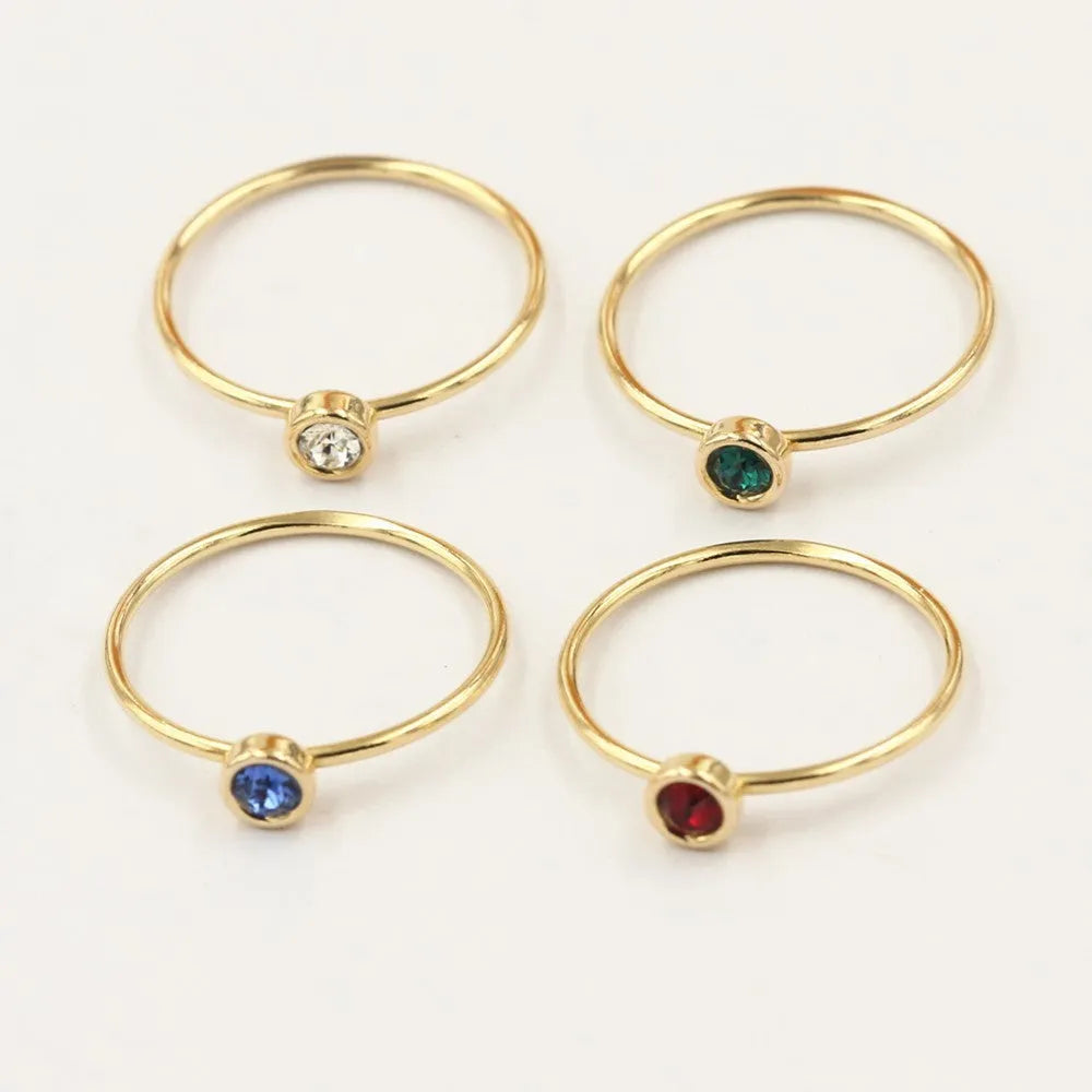 14K gold-plated GF zircon knuckle ring on finger in green colour