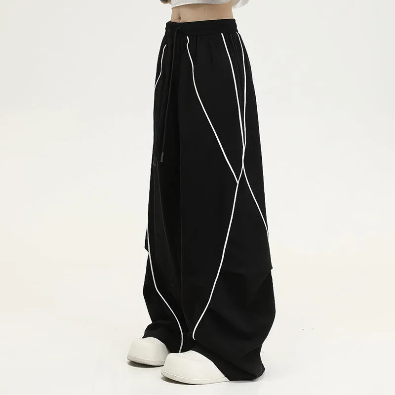Black and white striped pleated wide-leg hip hop pants on a neutral background