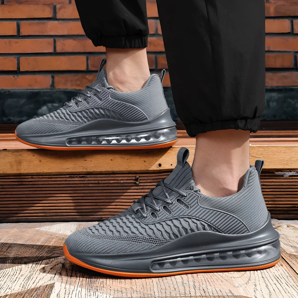 Men's black low-top running shoes with mesh upper and white rubber sole on a plain background.
