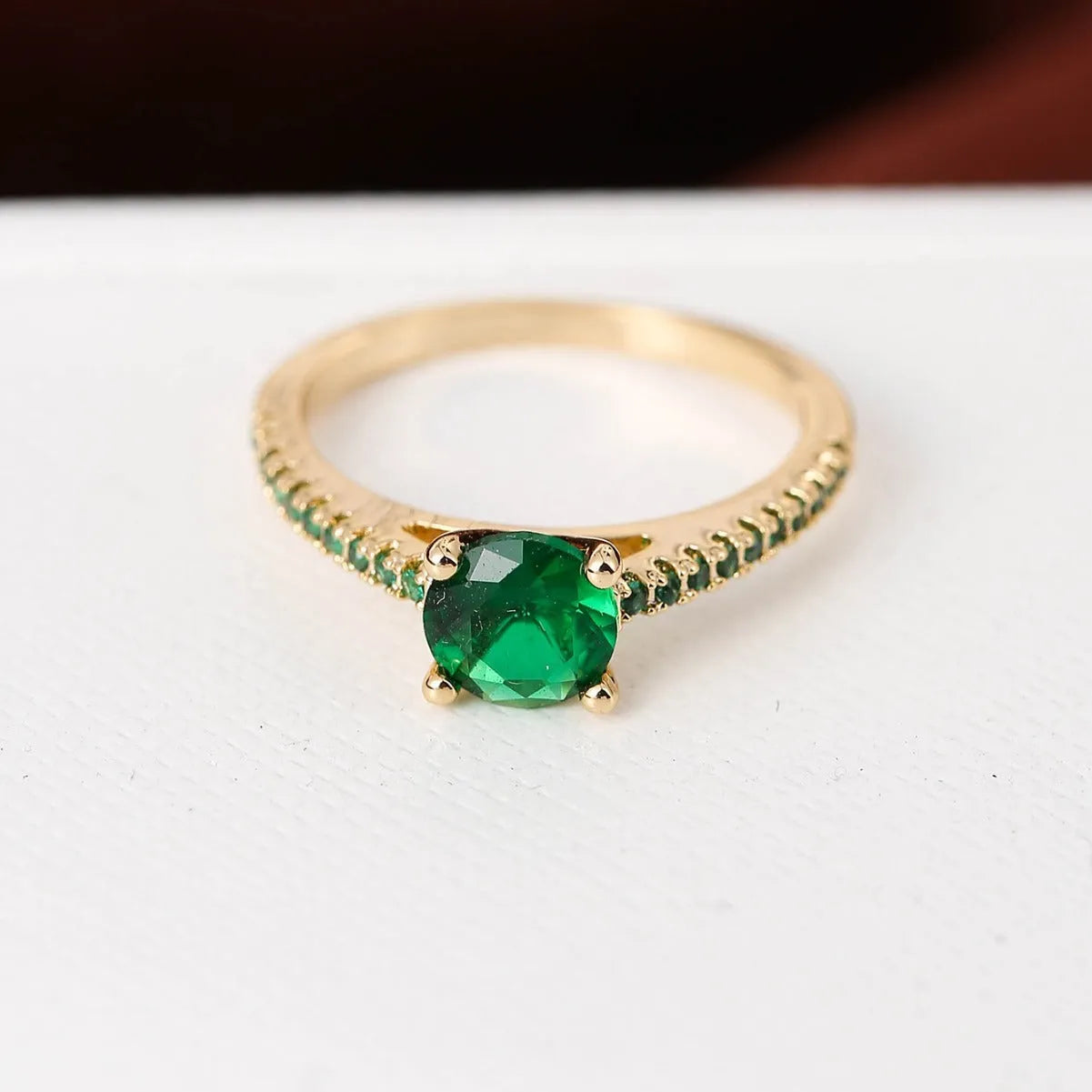 Geometric hexagon copper ring with colourful zircon stones in a metallic electroplated finish.