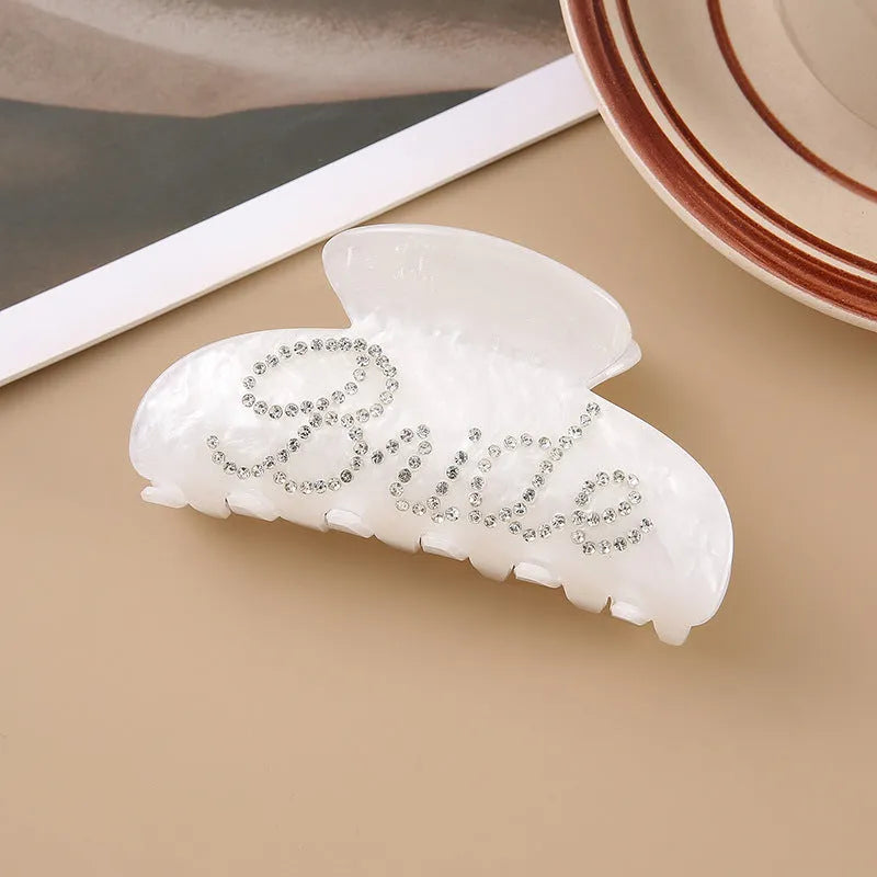 Acrylic hair barrette with sparkling diamond spot drills and English letters in pink or white.