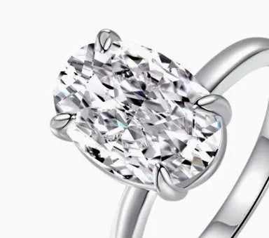 Oval 9 silver ring with four-claw setting holding 6x9mm hand-cut gemstone