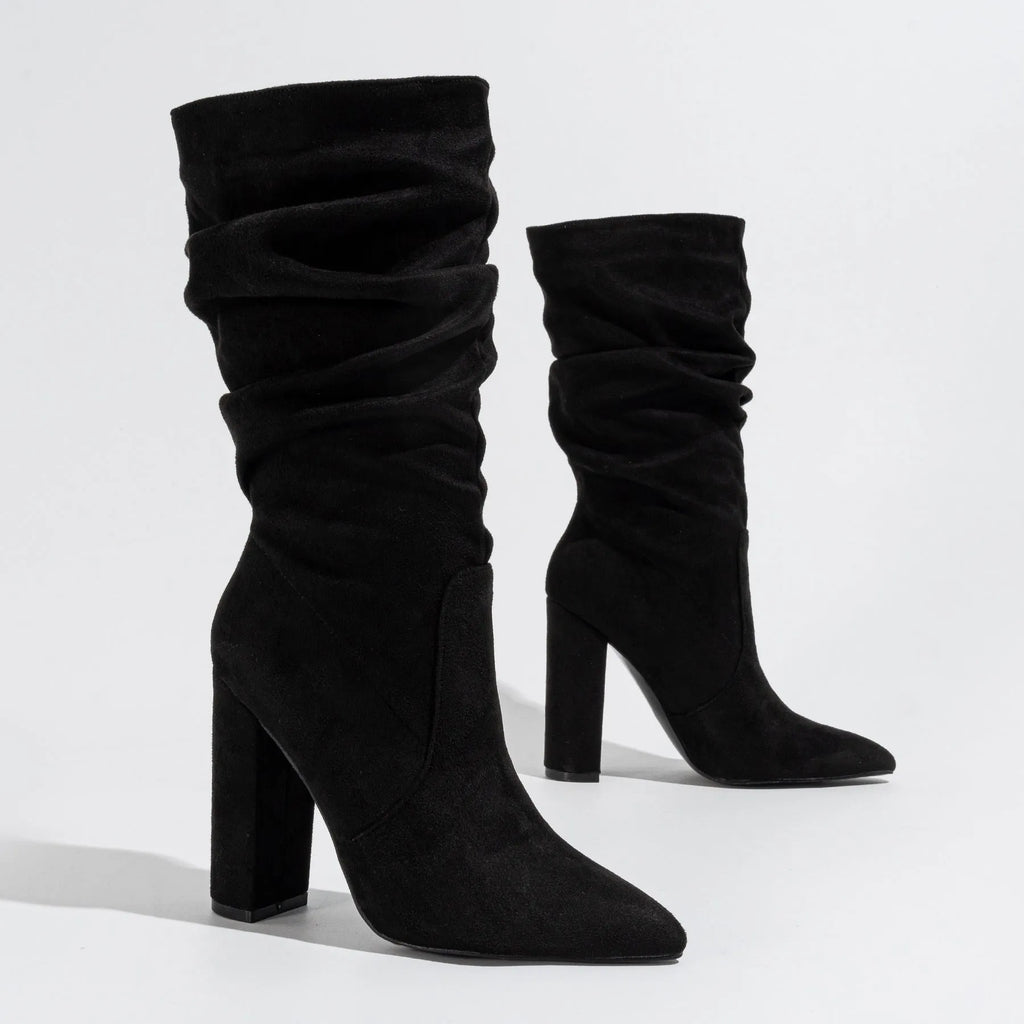 Women's black suede ankle boots with a high chunky heel and pointed toe.