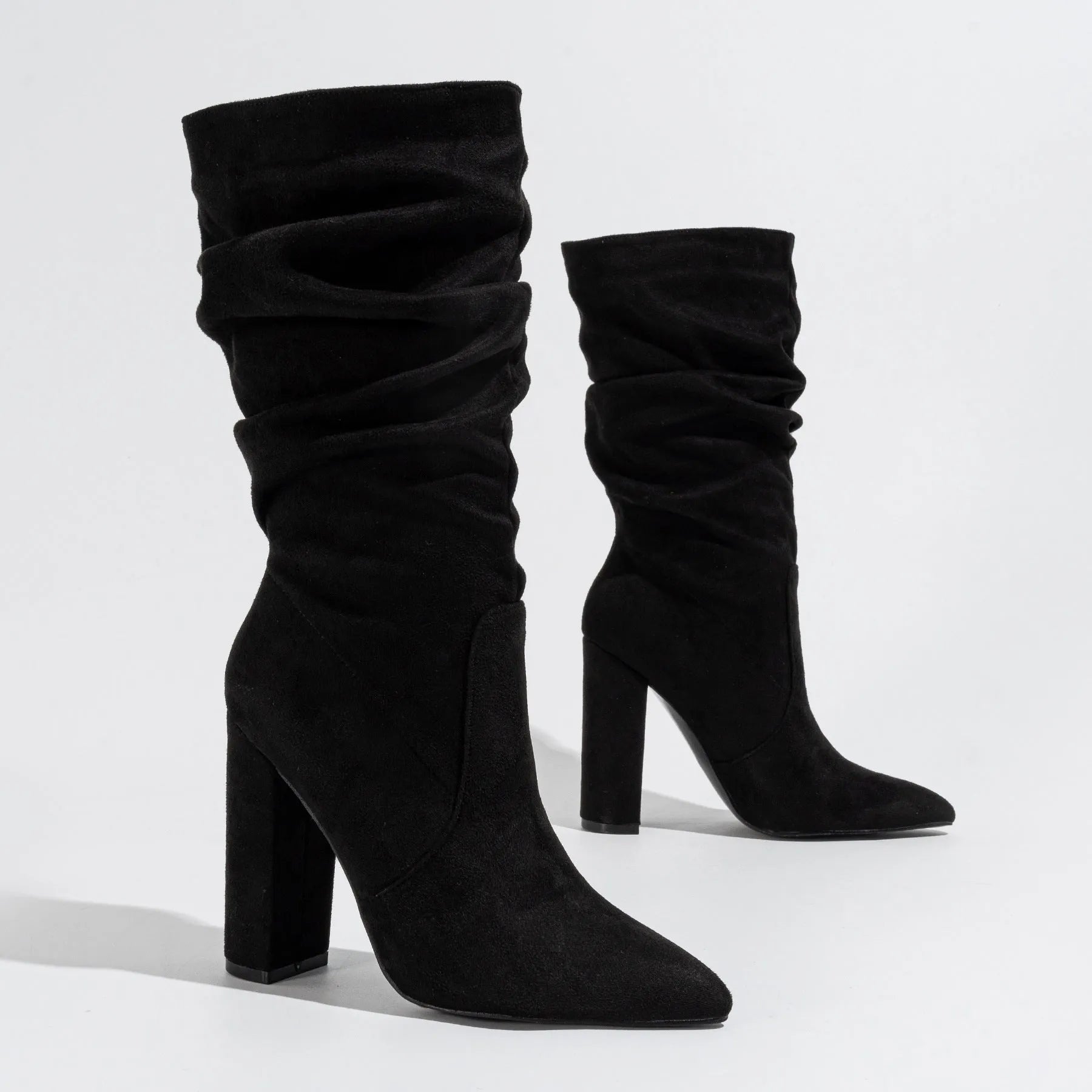 Women's black suede ankle boots with a high chunky heel and pointed toe.