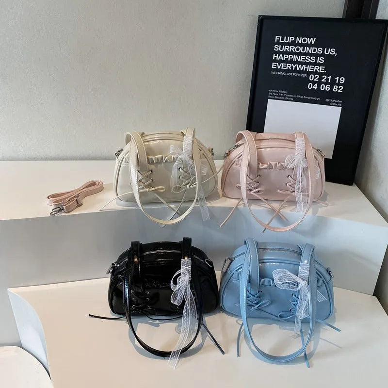 Milky white women's PU leather shoulder bag with a removable bandage bow and visible sewing thread detailing