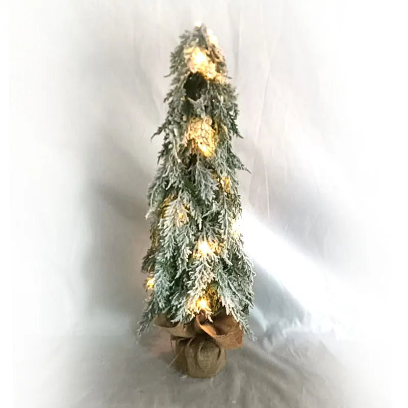 24 inch plastic Christmas tree with lights and PE snow decoration on desktop