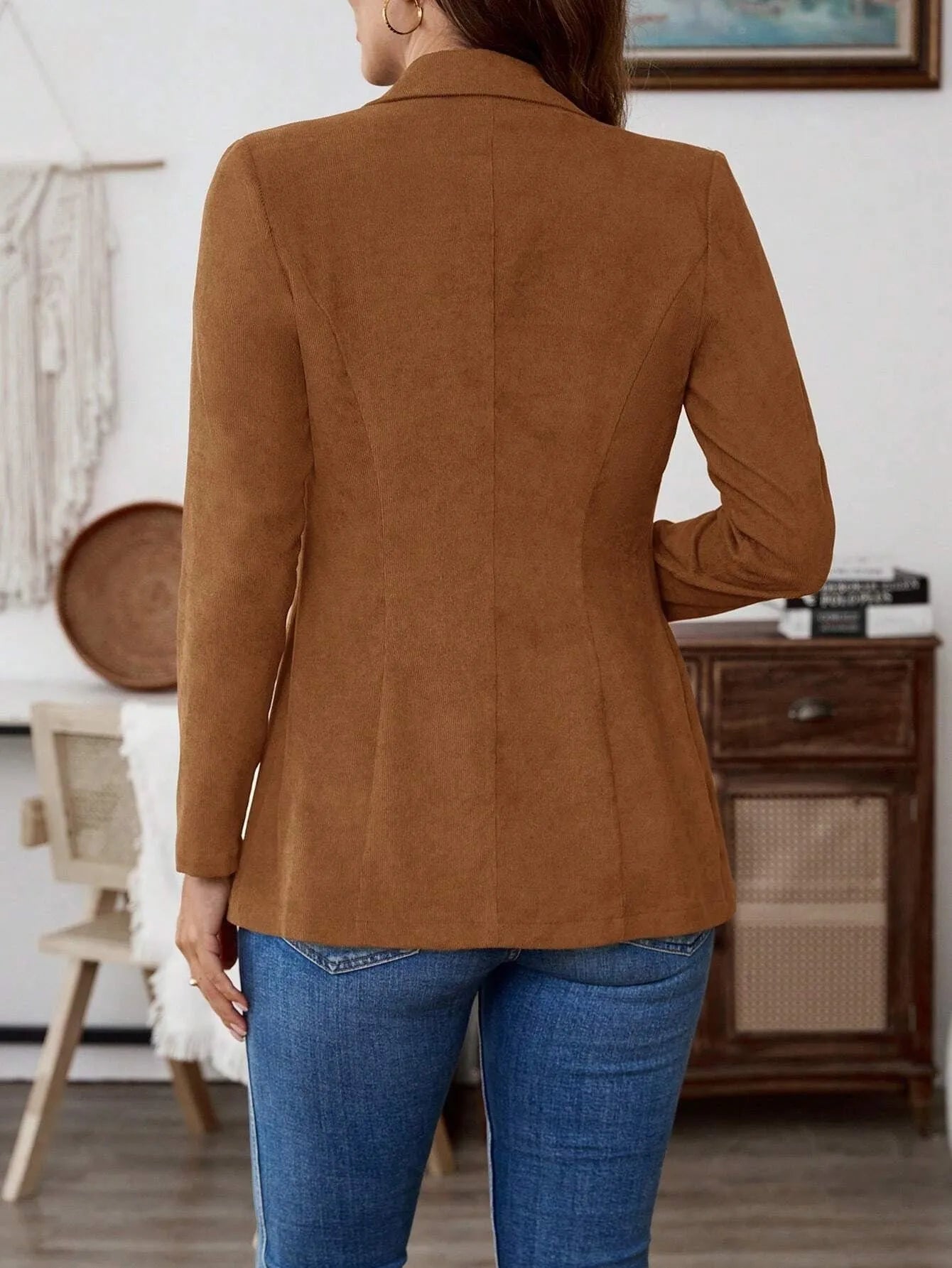 Brown single-breasted leisure suit coat with lapel collar and long sleeves on hanger